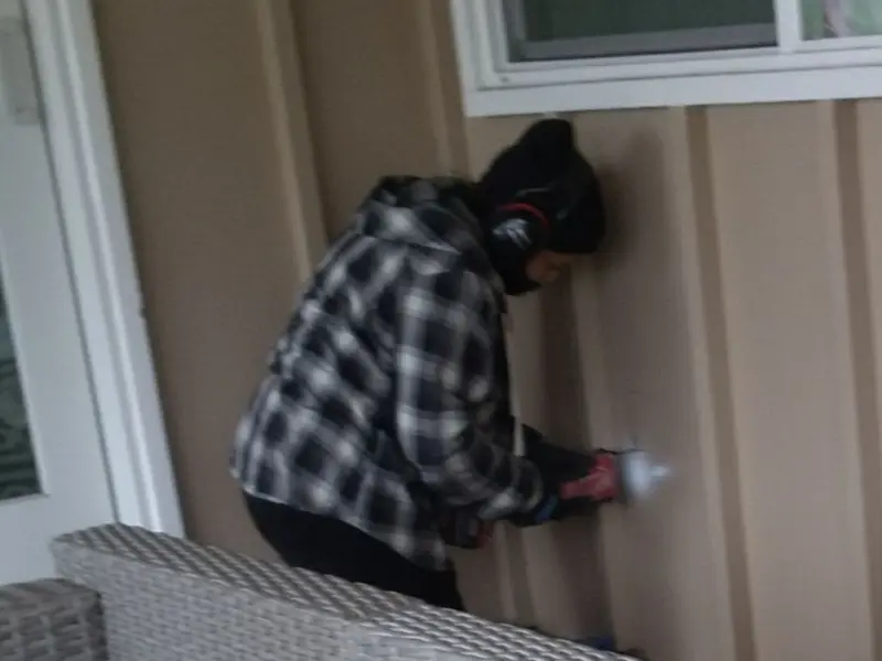 Professional electrician installing an exterior outlet in Chesterfield